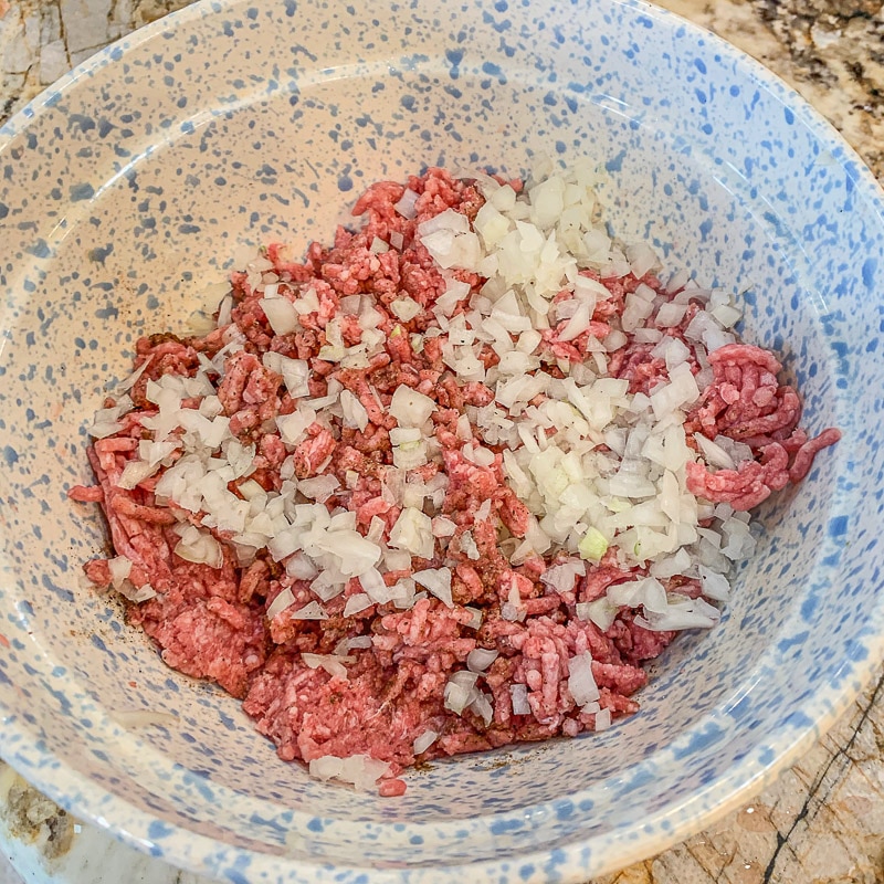 ground meat and diced onions in a bowl