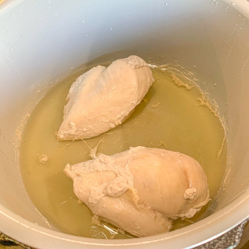 cooked chicken breasts in broth
