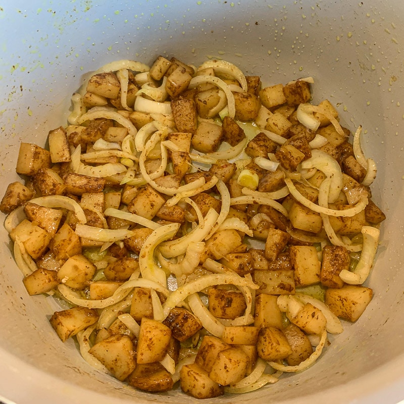 potatoes and onions being sautéed in an instant pot