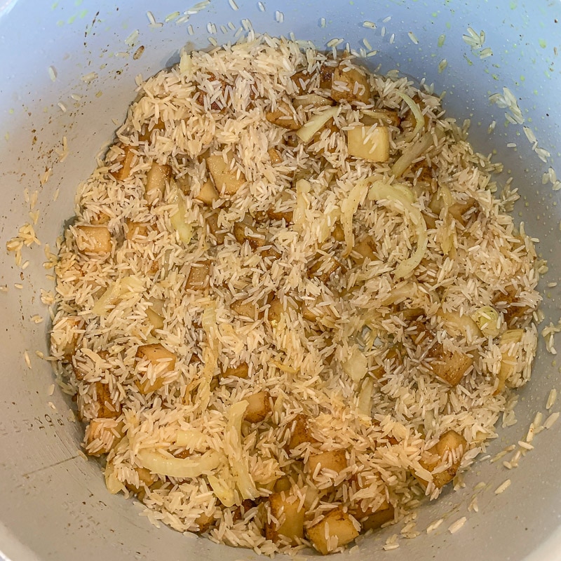 chicken, rice, and potatoes in the bottom of an instant pot