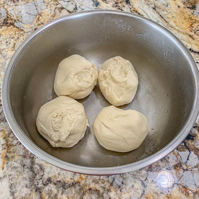 4 dough balls in a bowl