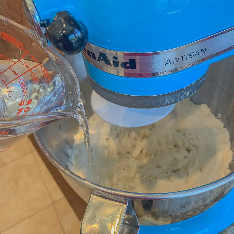 douring water into stand mixer with flour