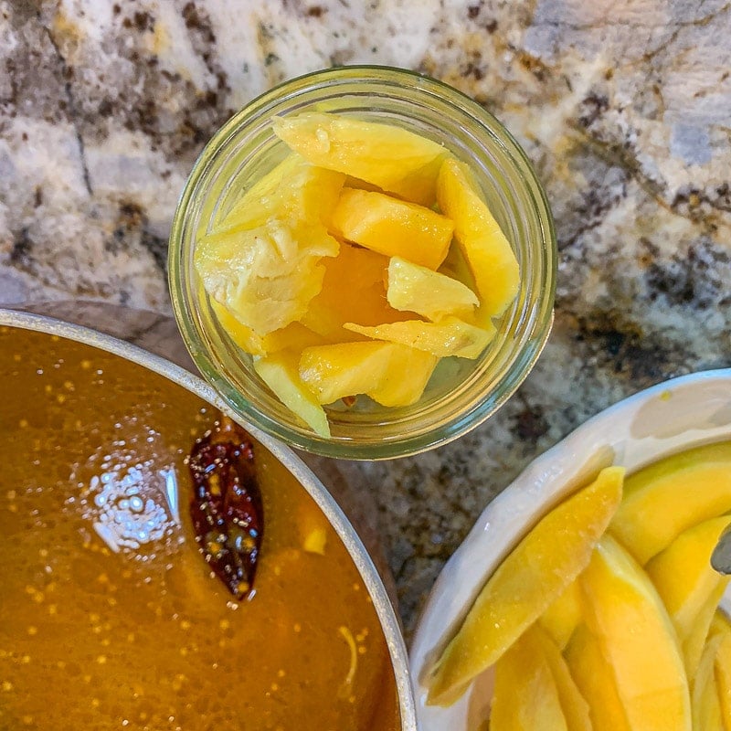 mangos in a jar with brine on the side