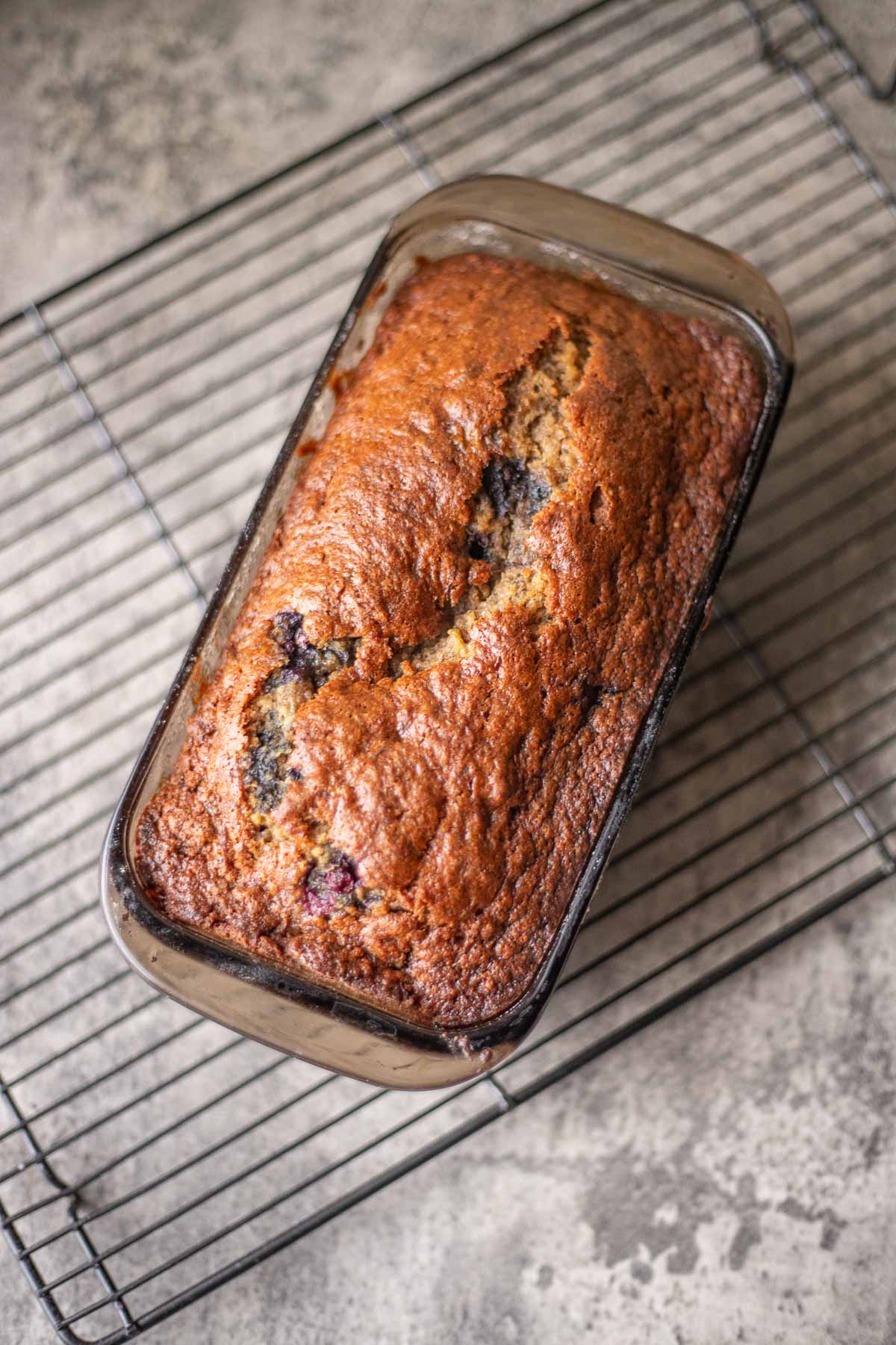 blueberry banana bread cooling on a rack