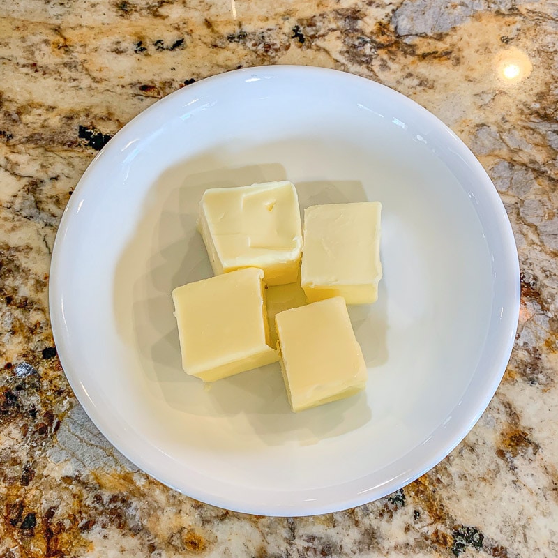 cubed butter in a small white bowl