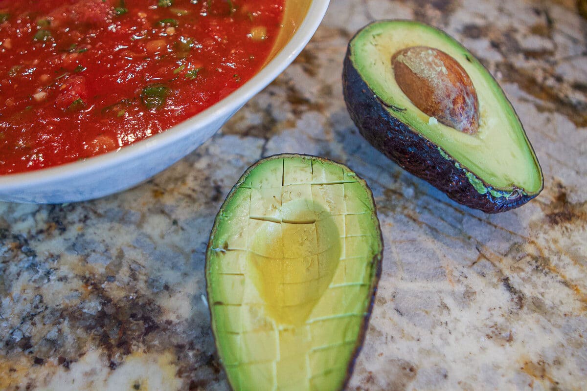 salsa with an avocado that's cut in half 