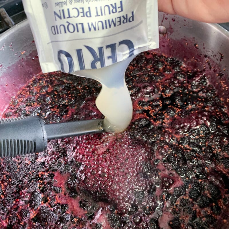 squeezing pectin jell in berry preserves