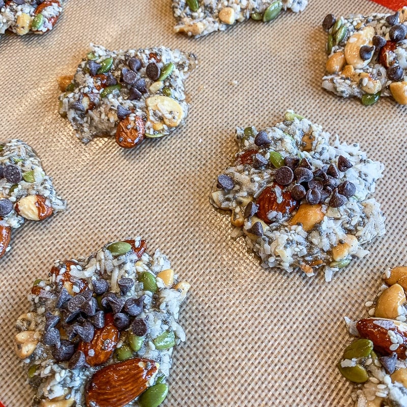 unbaked nut clusters with mini chocolate chips on top of them