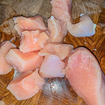 raw, chopped chicken on a cutting board
