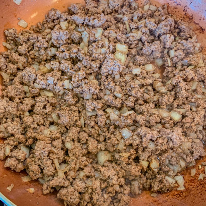 ground beef and onions in a skillet