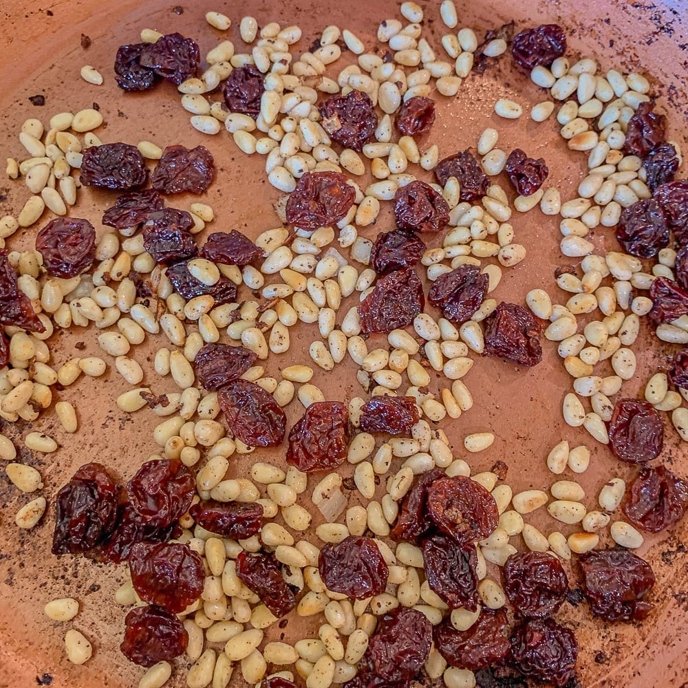 pine nuts and raisins in a skillet