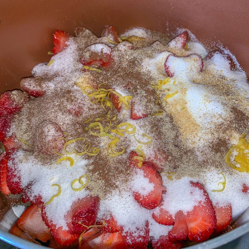 strawberry jam ingredients in a brown pot