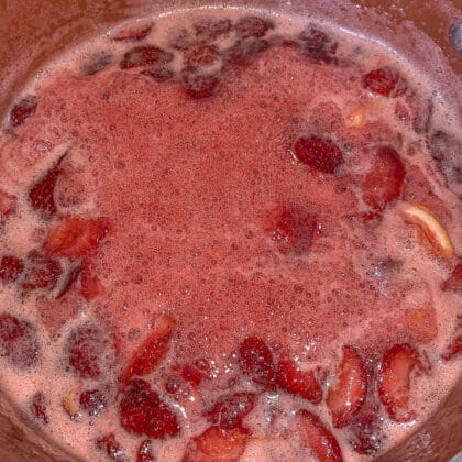foaming stawberry rhubarb jam in a pot