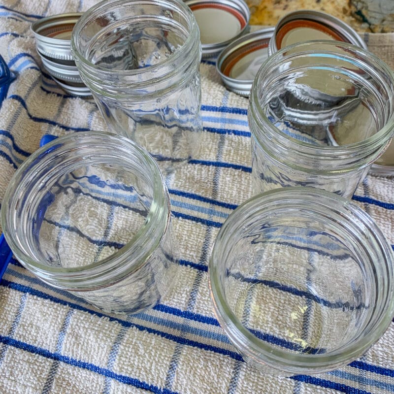 empty canning jars on a blue and white dish towel