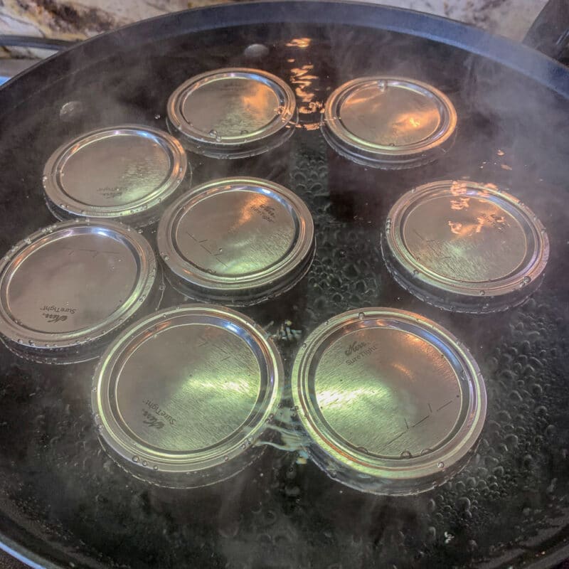 8 canning jars being processed in boiling water