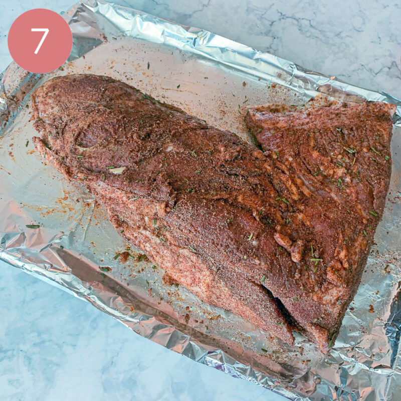 raw, seasoned, tri-tip roast on a foil-lined pan