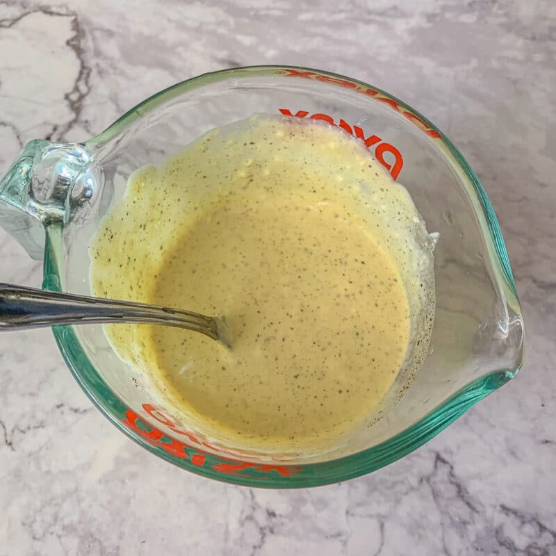 salad dressing in a measuring cup