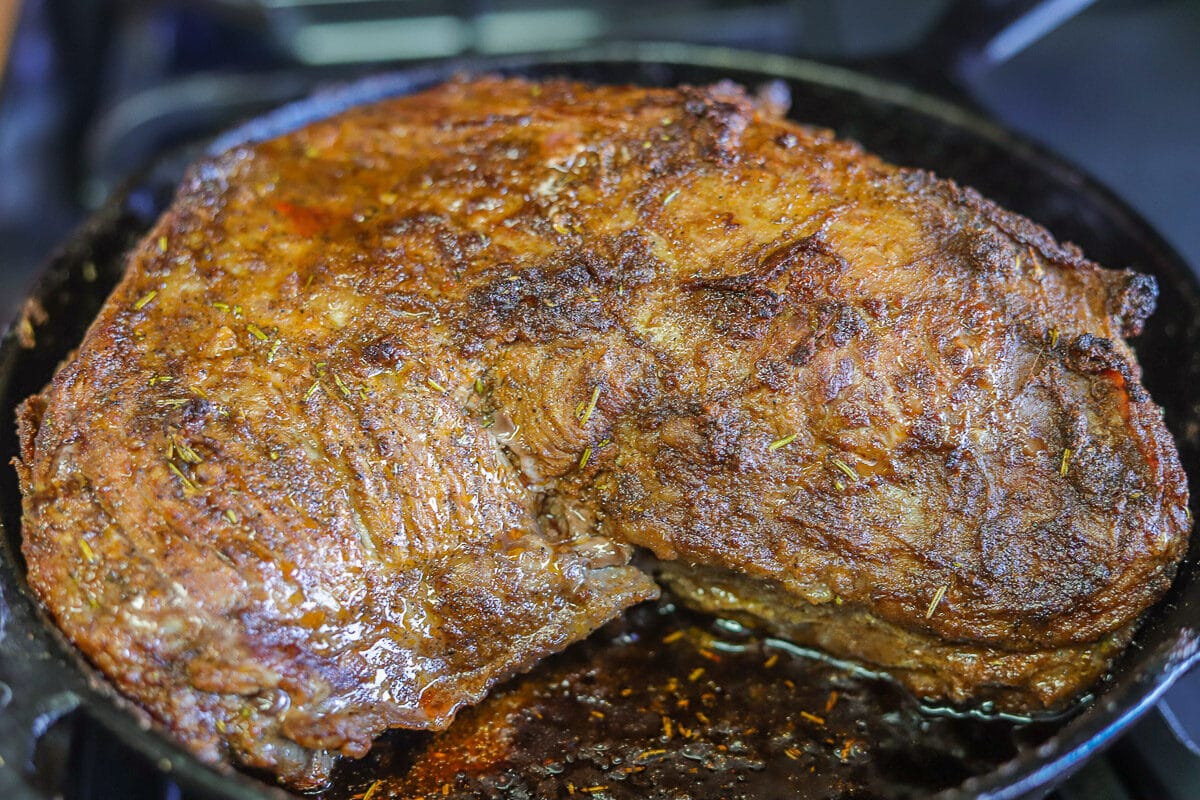 Perfectly cooked tri-tip roast in a cast iron pan 