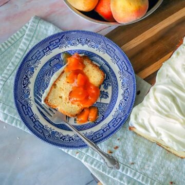 peach cobbler pound cake on a blue plate with peaches and loaf next to it