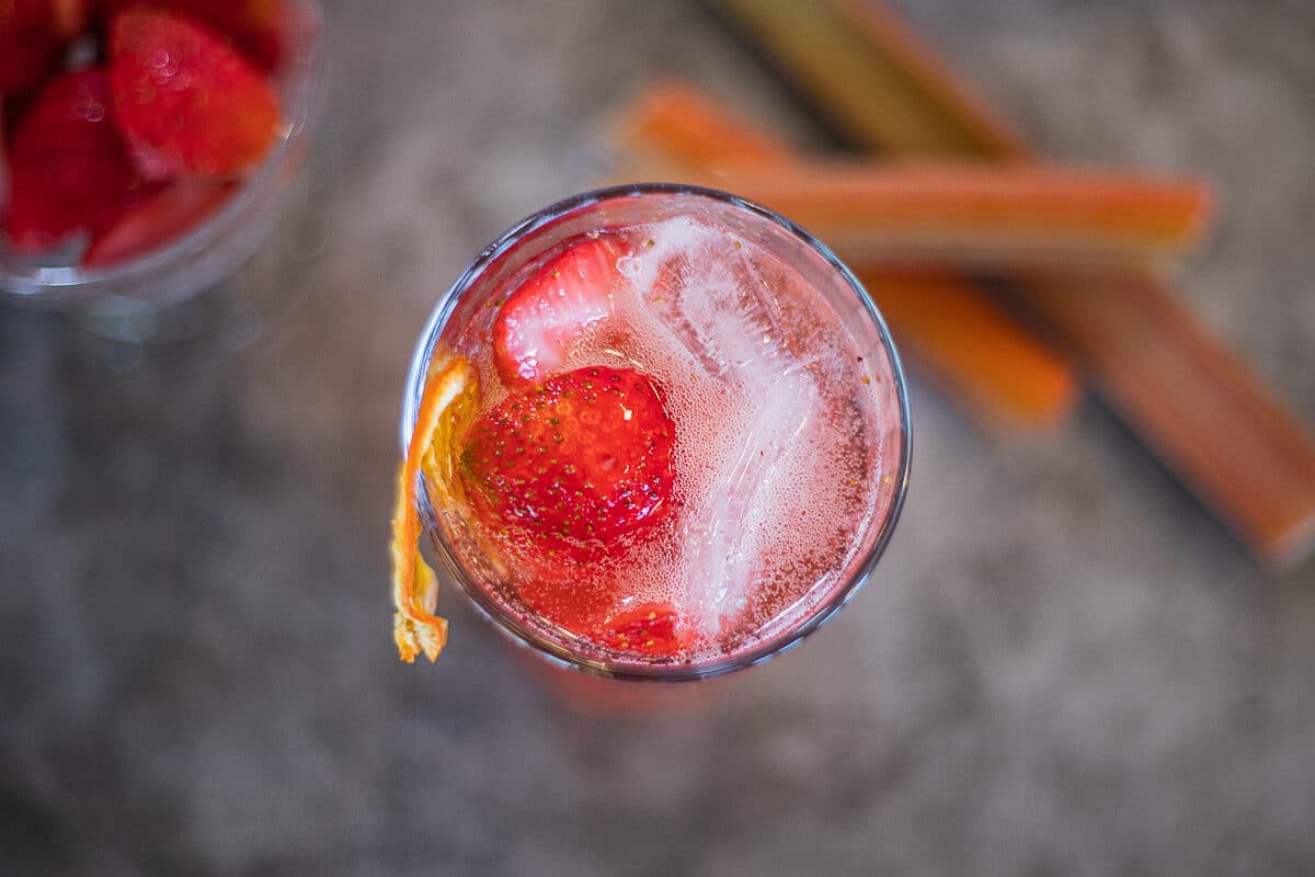 rhubarb cocktail over ice and strawberries