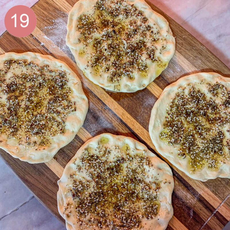 four mini Manaqish bread dough on a cutting board