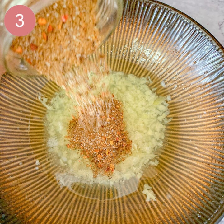adding seasoning to marinade in a brown bowl