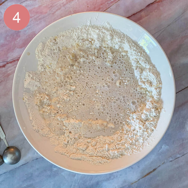 a bowl of flour and liquid with yeast for bread