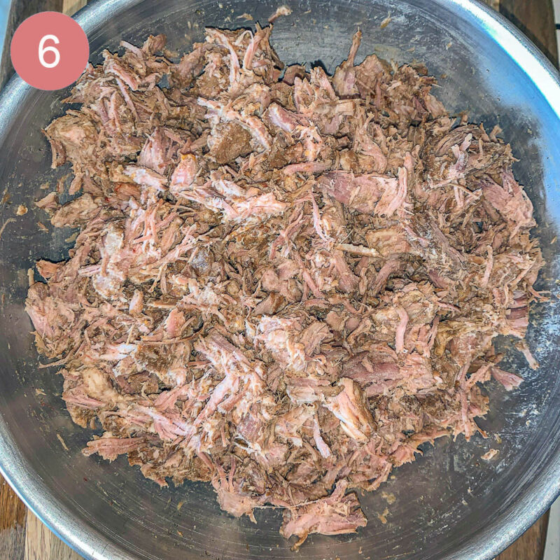 shredded beef in a silver bowl