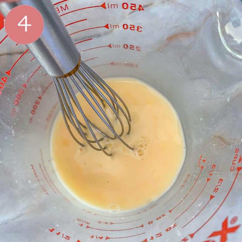 whisking liquid in a measuring cup