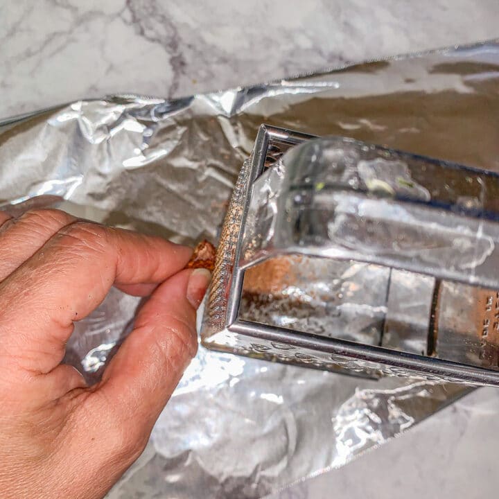 grating nutmeg on a piece of foil