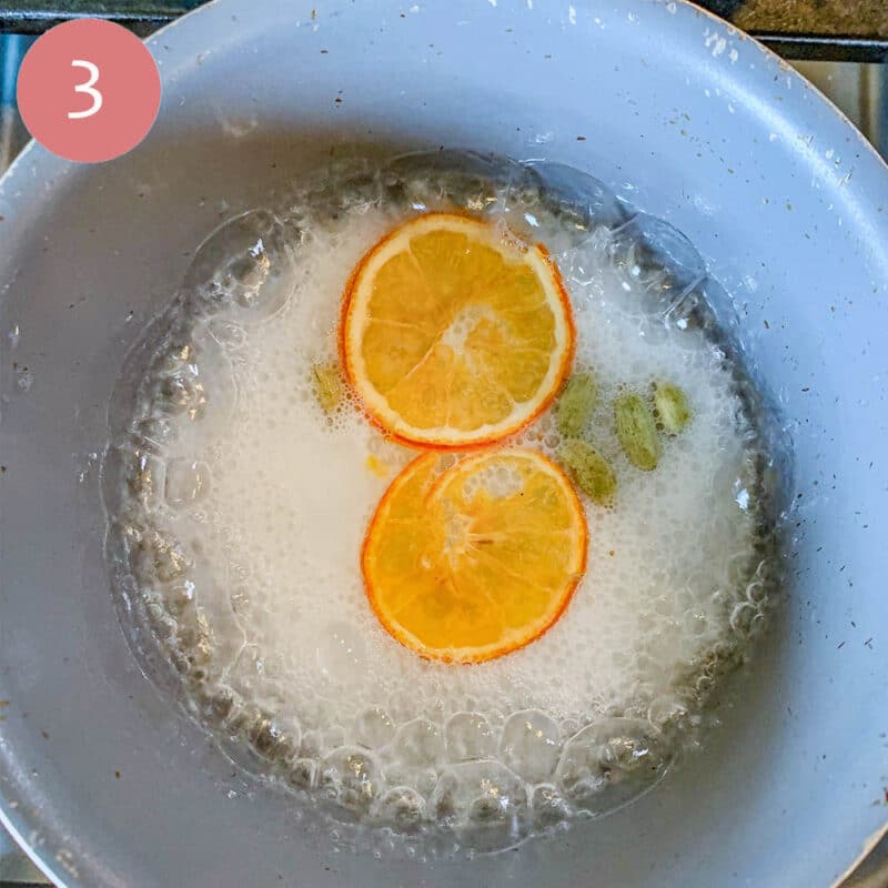 boiling simple syrup with cardamom and orange slices