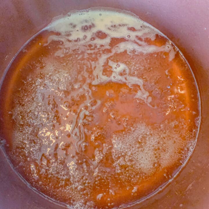 rosehips syrup simmering in a pot