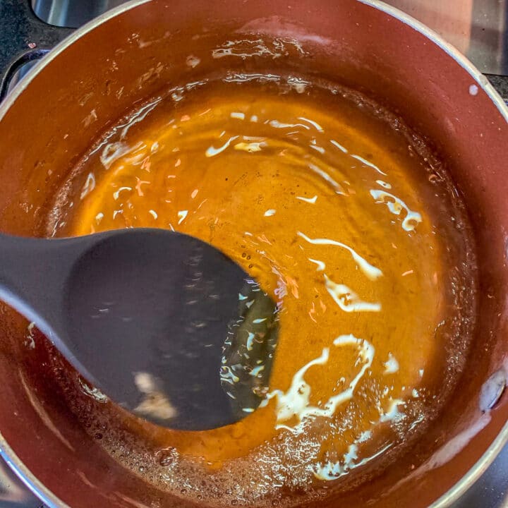 stirring syrup with a wooden spoon