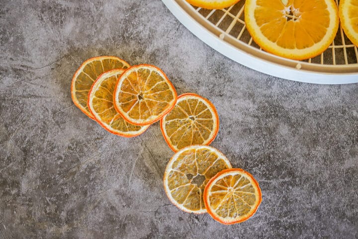 dehydrated oranges next to a dehydrator