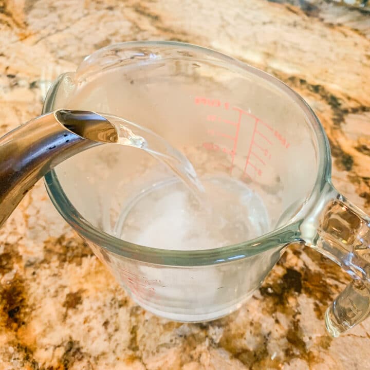 pouring boiling water in a measuring cup