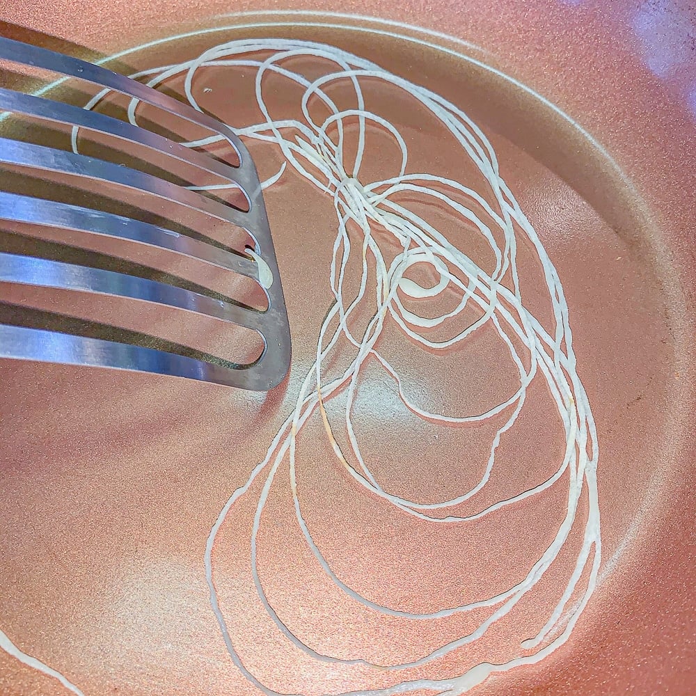 strands of pasty in a pan