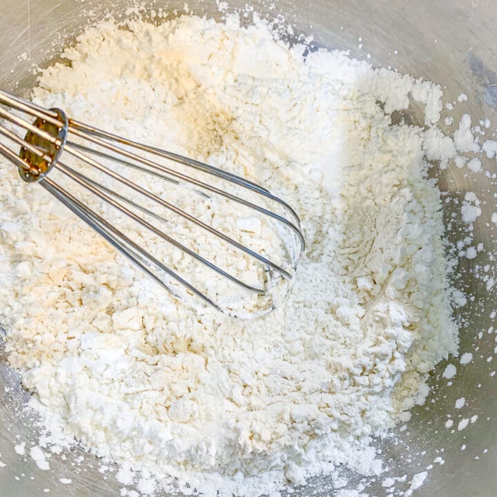 whisking flour in a silver bowl for Kataifi 