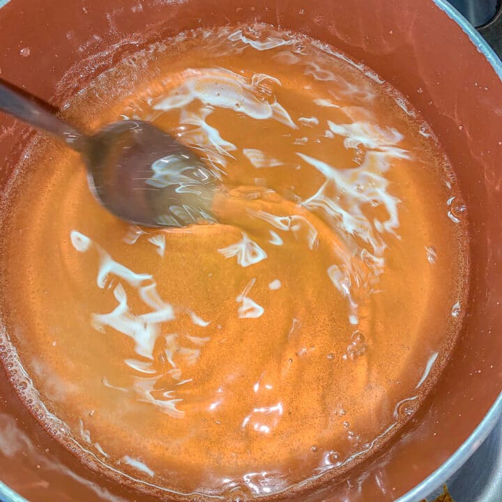 syrup in a pot being stirred