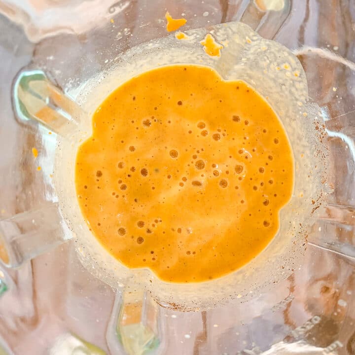 orange drink in a blender, top view