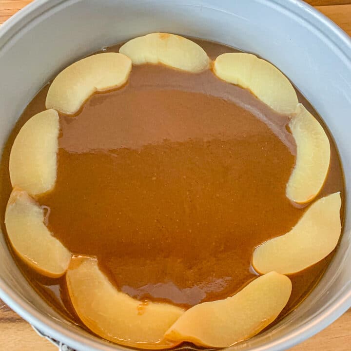caramel in a springform pan with sliced fruit around it