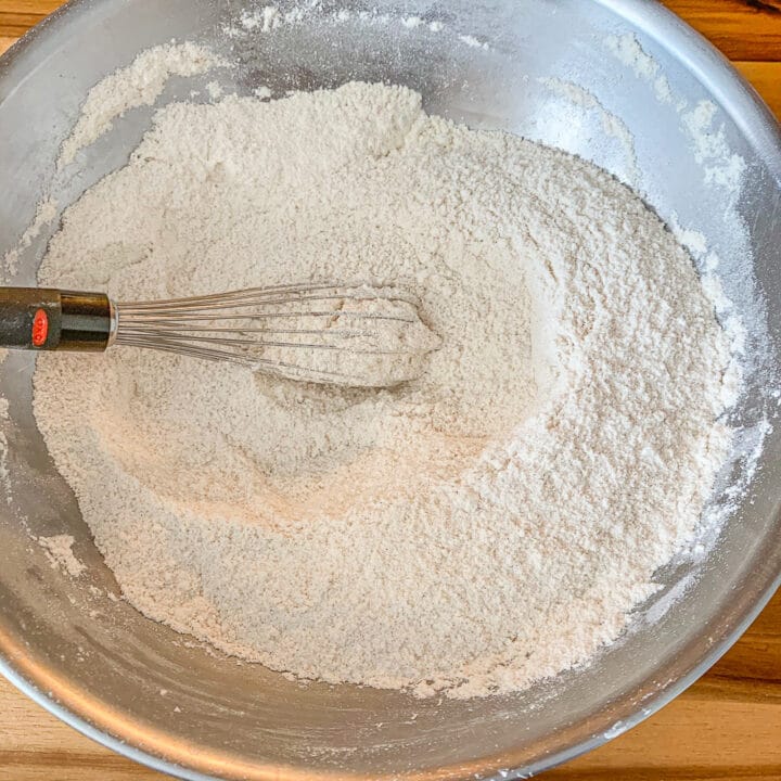 flour mix in a silver bowl with a whisk