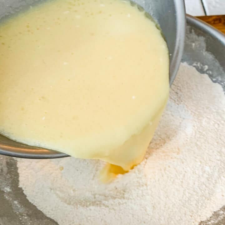 wet ingredients being poured into dry ingredients