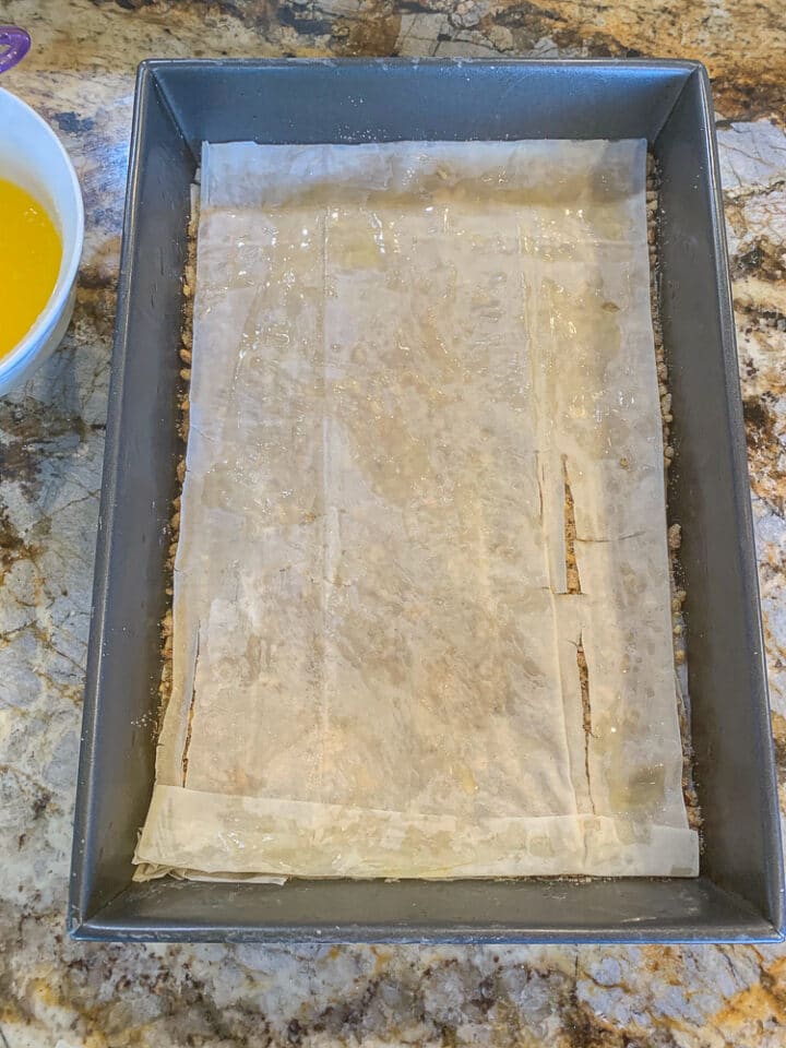 layers fillo sheets for baklawa in a pan