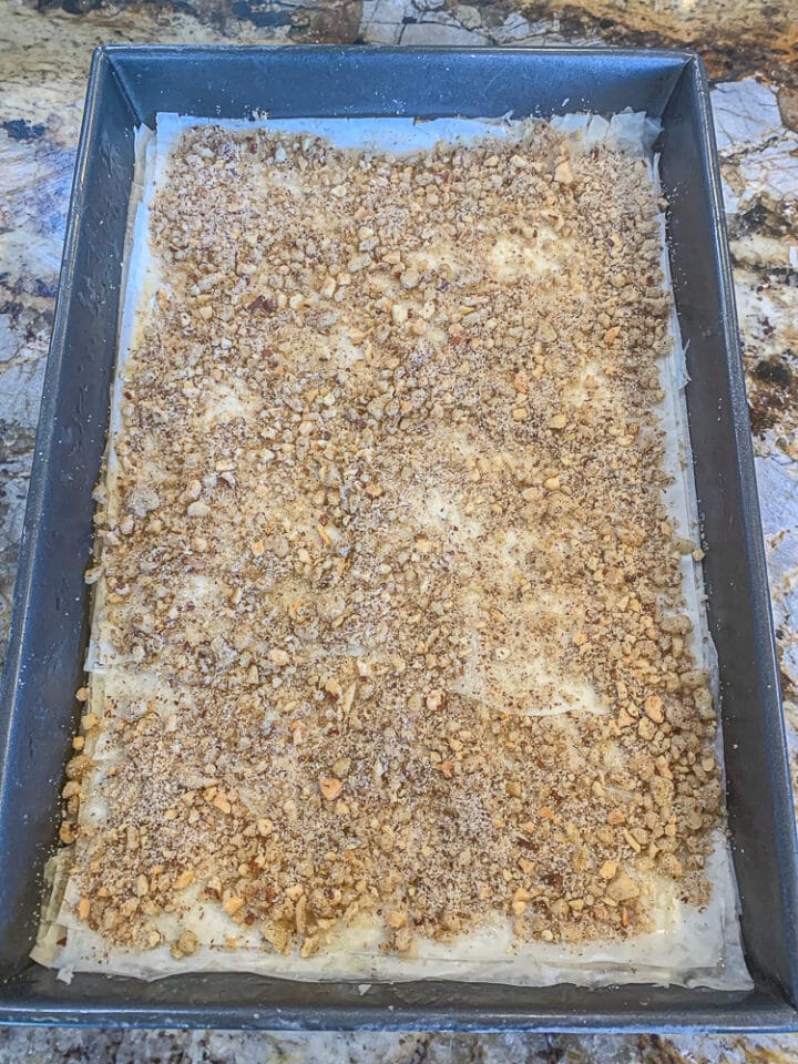 layered nuts and fillo in a pan for baklava