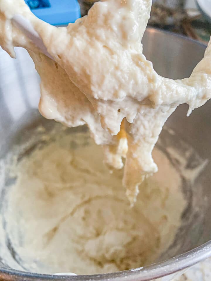 paddle attachment of mixer, covered with dough
