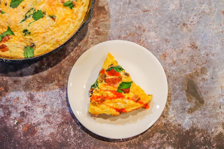 low carb frittata slice on a white plate