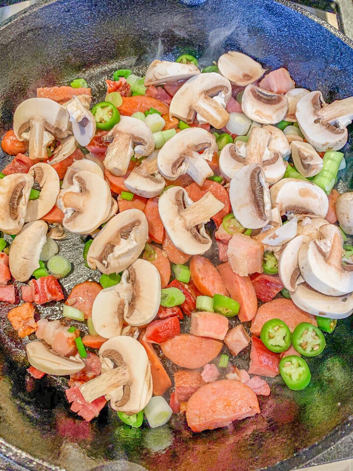 chopped veggies and meat in a cast-iron skillet