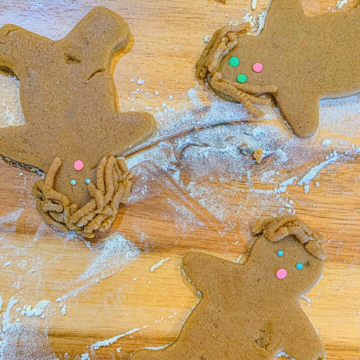 unbaked gingerbread men cookies on a cutting board