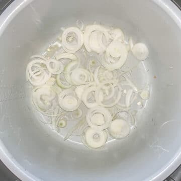 a pot with sliced onions in it