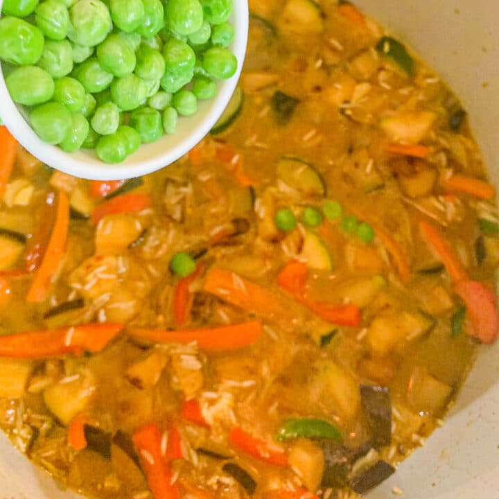 adding peas to vegetable biryani